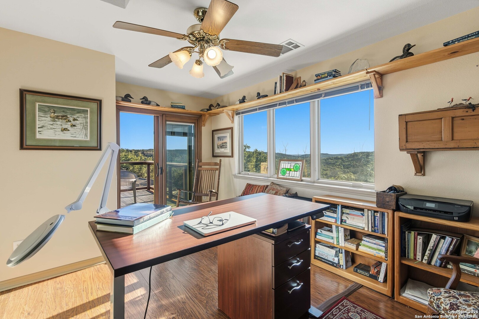 9623 Requa Road Helotes, TX 78023 - Photo 31 of 49 a view of a dining room with furniture window and wooden floor