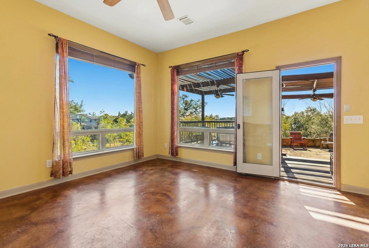 9623 Requa Road Helotes, TX 78023 - Photo 9 of 49 a view of a big room with wooden floor and windows
