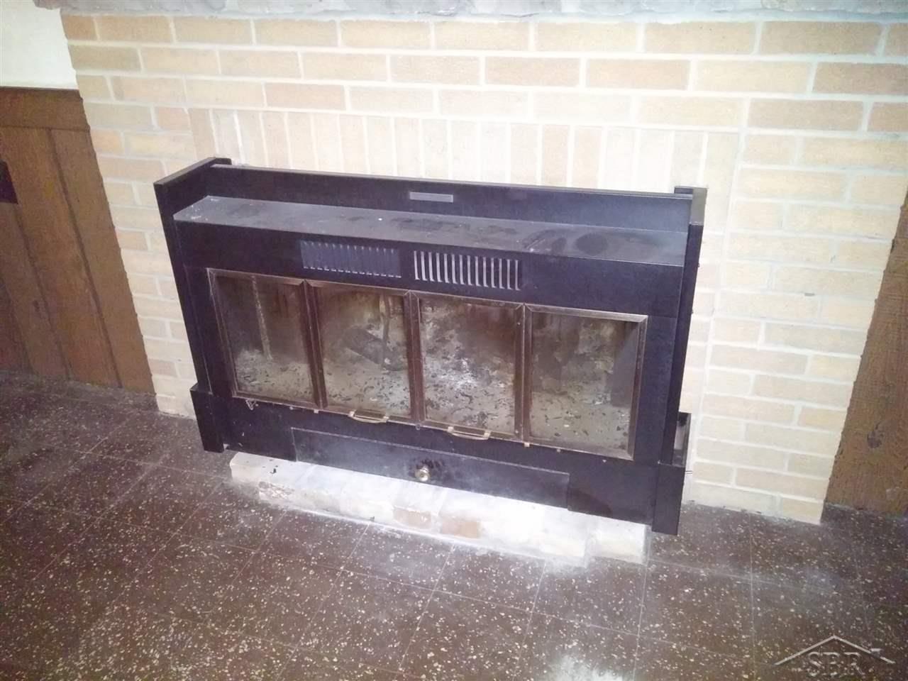 11455 Dice Road Freeland, MI 48623 - Photo 16 of 16 Fireplace with heatilator in family room in basement. Basement has wood loading door, for easy wood stocking