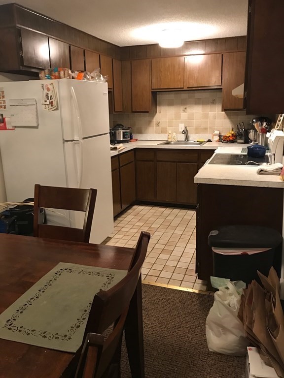 a kitchen with a sink cabinets and refrigerator