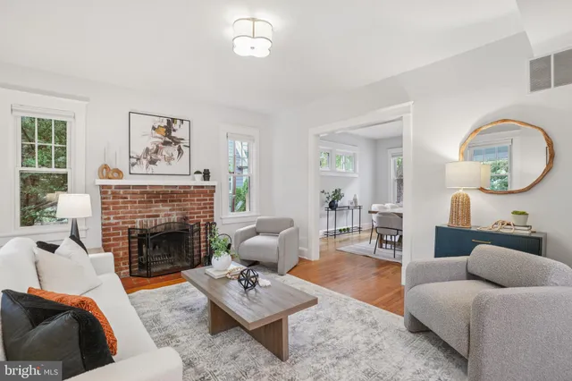 a living room with furniture a rug and a fireplace