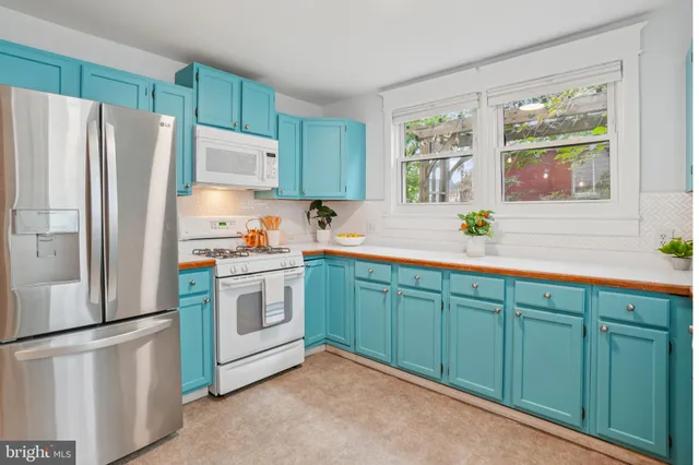 a kitchen with stainless steel appliances granite countertop a refrigerator sink and cabinets