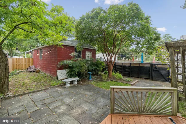 a view of backyard with outdoor seating and green space