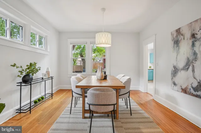 a view of a dining room with furniture window and wooden floor