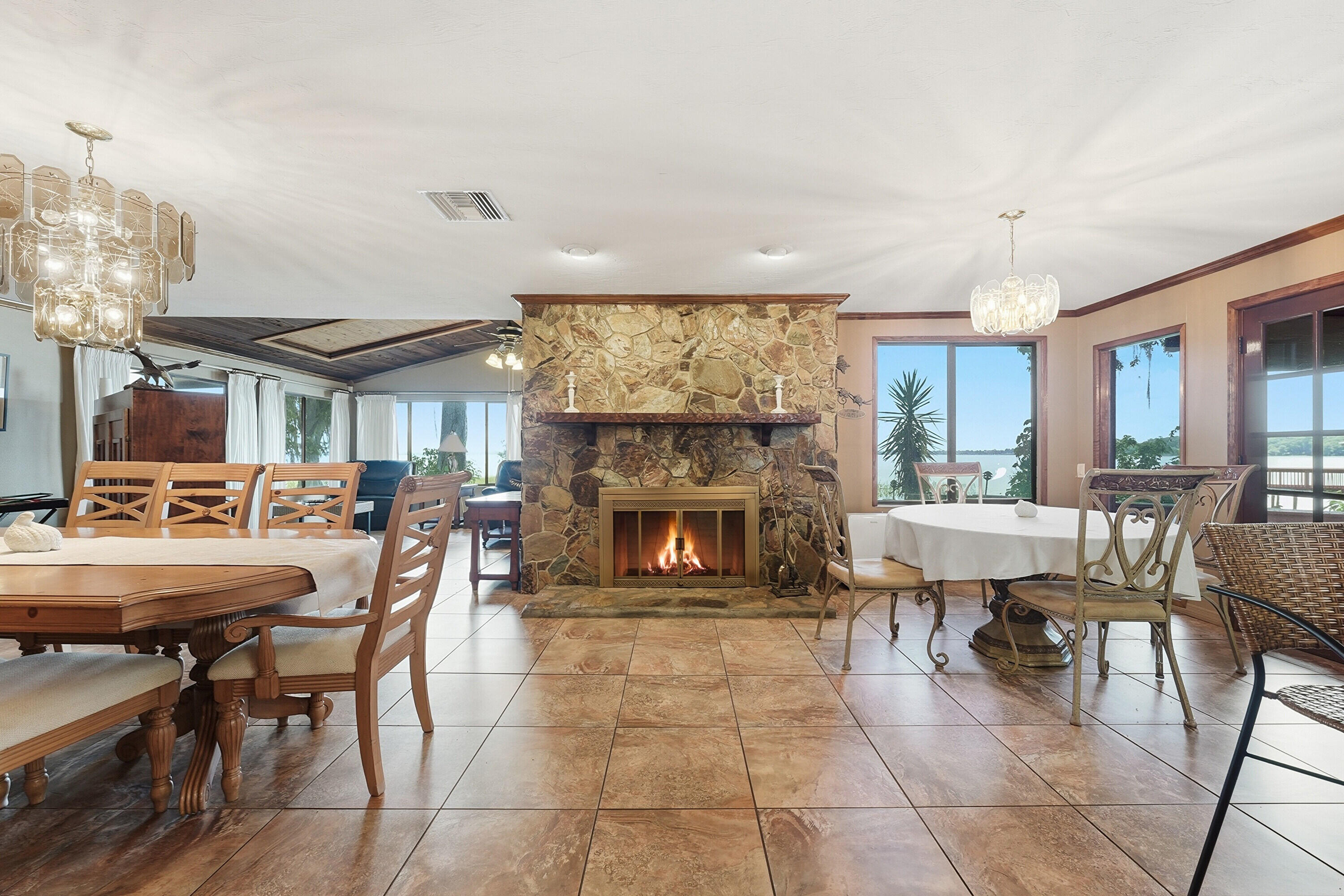 200 Windy Point Road Lake Placid, FL 33852 - Photo 8 of 74 a living room with furniture a fireplace and a chandelier