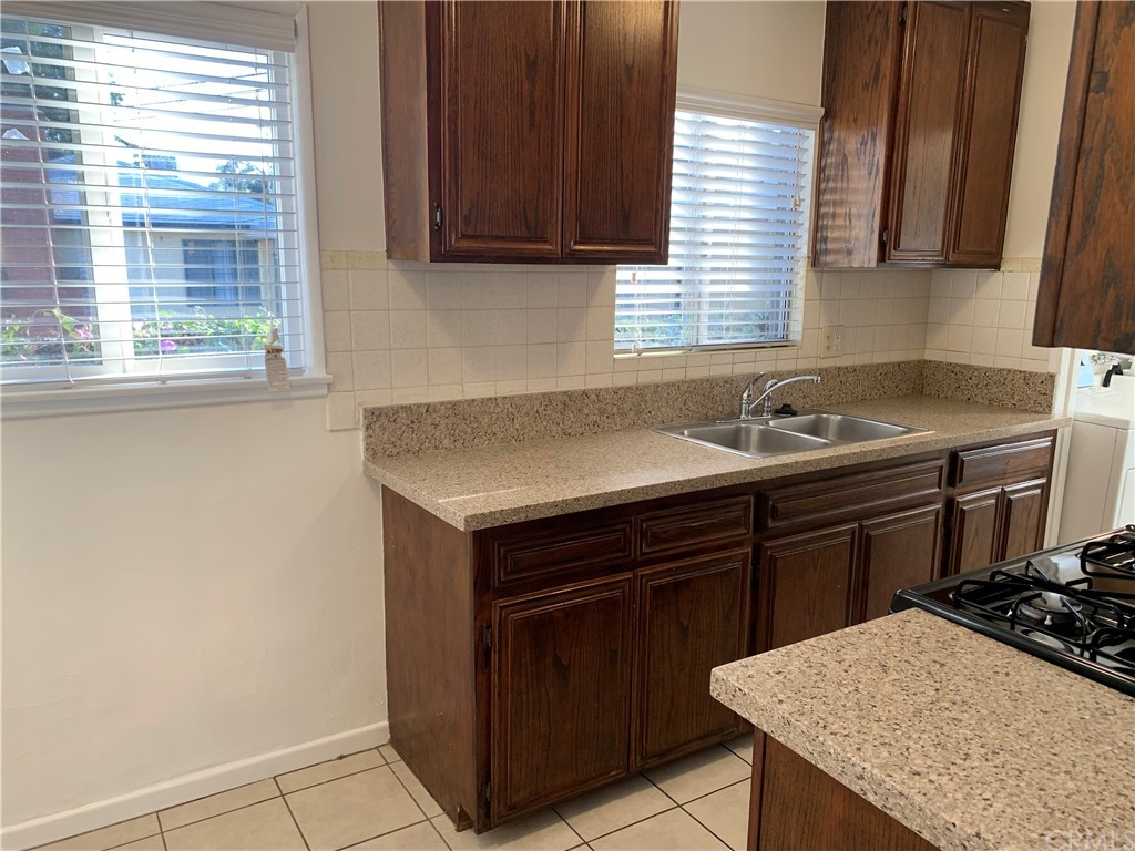 447 Martelo Avenue Pasadena, CA 91107 - Photo 12 of 24 a kitchen with a sink stove and cabinets