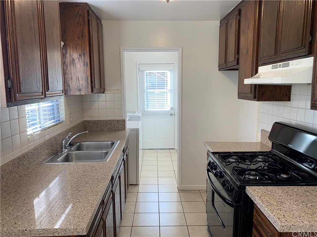 447 Martelo Avenue Pasadena, CA 91107 - Photo 13 of 24 a kitchen with granite countertop stainless steel appliances a sink stove and cabinets