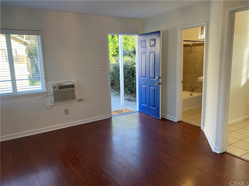 447 Martelo Avenue Pasadena, CA 91107 - Photo 4 of 24 an empty room with wooden floor and windows