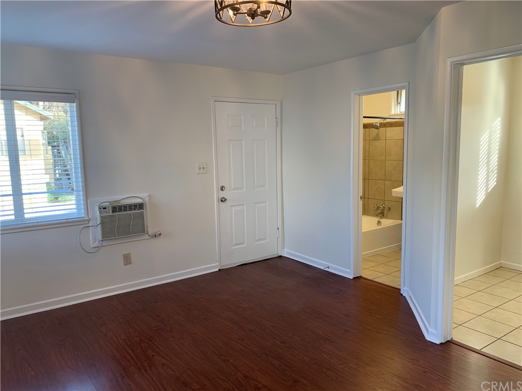 447 Martelo Avenue Pasadena, CA 91107 - Photo 6 of 24 an empty room with wooden floor and windows