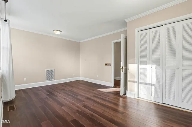 a view of backyard with wooden fence and a large tree