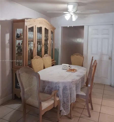 a dining room with a table chairs and a chandelier
