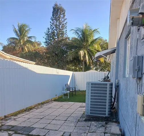 a view of a pathway of a house with a small yard