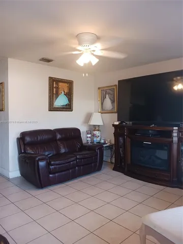 a living room with couches and a flat screen tv