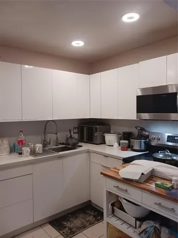 a kitchen with a sink a stove and cabinets