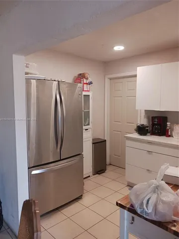 a kitchen with stainless steel appliances a refrigerator and a sink