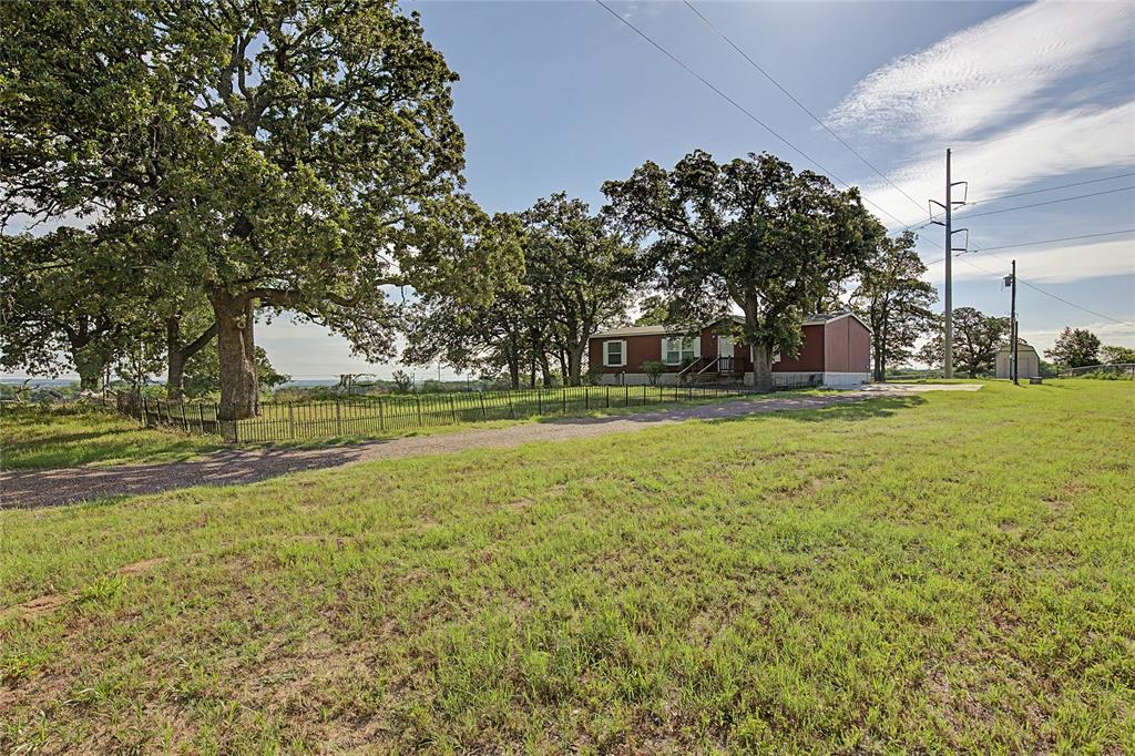 177 New Highland Road Springtown, TX 76082 - Photo 40 of 40 Expansive grassy terrain with mature trees providing shade