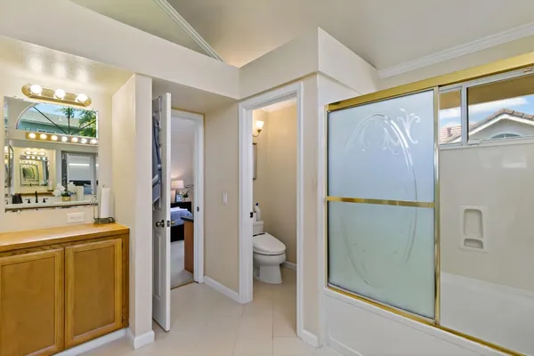 a bathroom with a granite countertop sink mirror and toilet