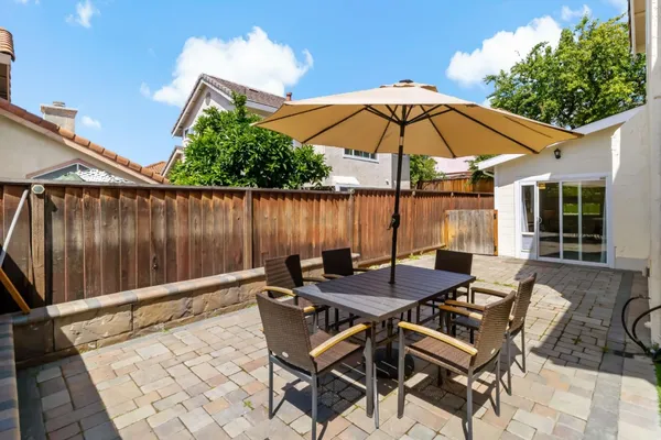 a view of an outdoor space with furniture and umbrella