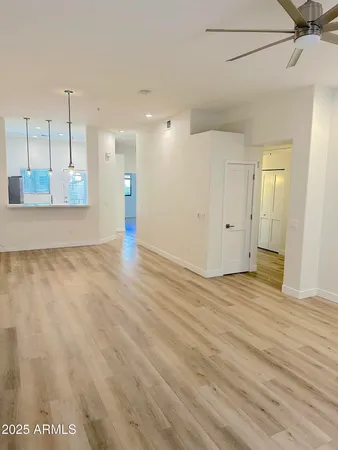 a view of a room with wooden floor and window