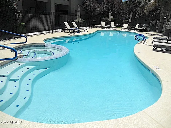 a swimming pool with chairs