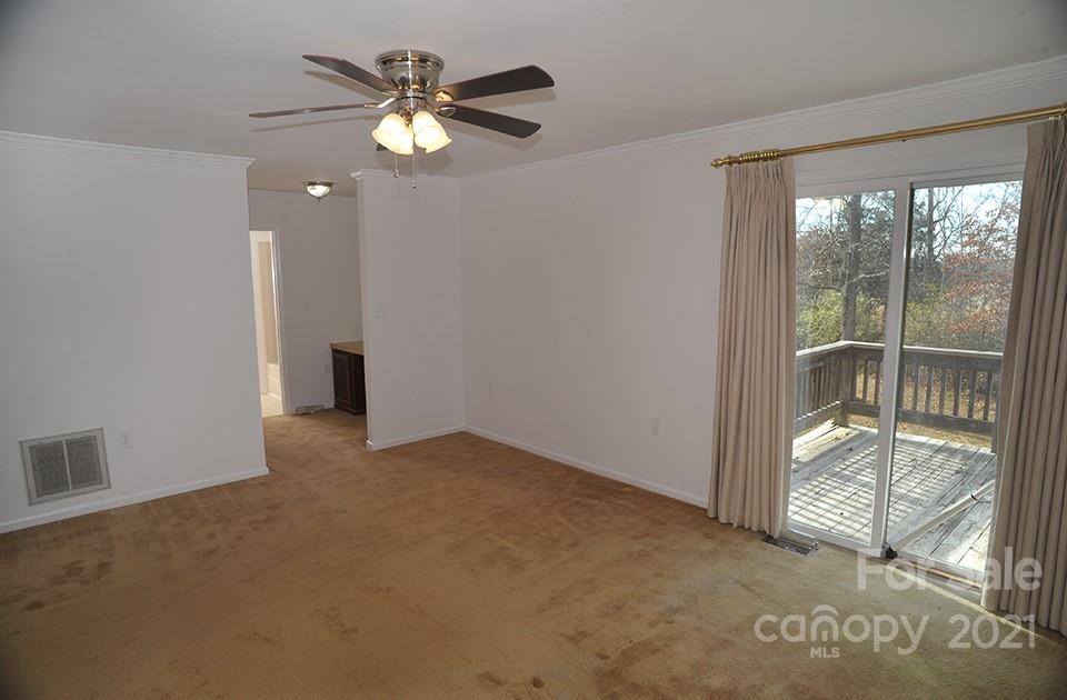 1220 Brison Road Woodleaf, NC 27054 - Photo 17 of 28 an empty room with fan and windows
