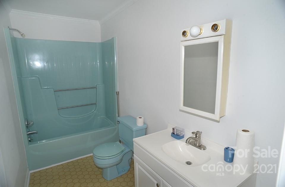 1220 Brison Road Woodleaf, NC 27054 - Photo 22 of 28 a bathroom with a sink a toilet and shower