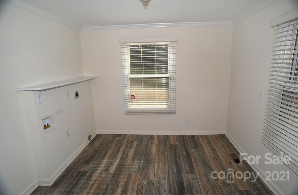1220 Brison Road Woodleaf, NC 27054 - Photo 23 of 28 a view of a room with wooden floor and white walls