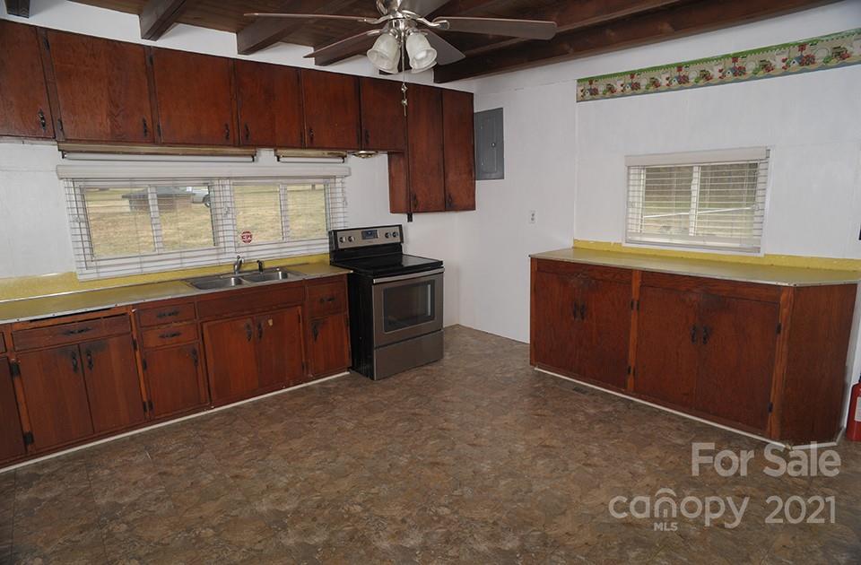 1220 Brison Road Woodleaf, NC 27054 - Photo 10 of 28 a kitchen with stainless steel appliances granite countertop a stove a sink and a microwave