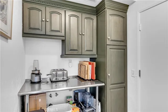 a kitchen with stainless steel appliances granite countertop a refrigerator and cabinets