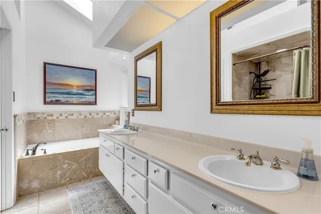 a bathroom with 2 sink and a bathtub