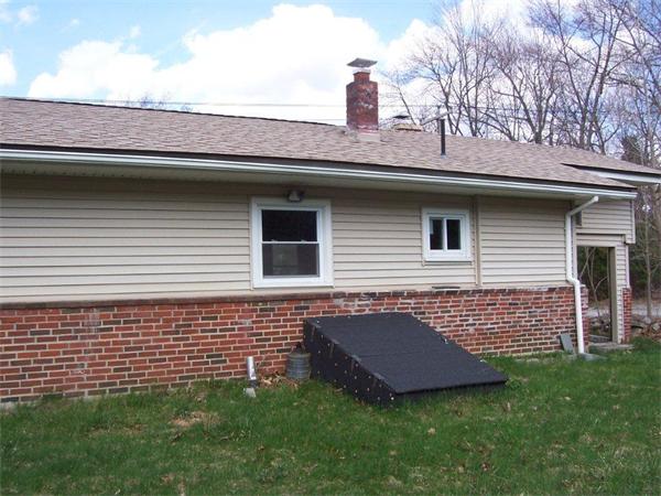 42 Ash Road Charlton, MA 01507 - Photo 3 of 8 a brick house with a yard