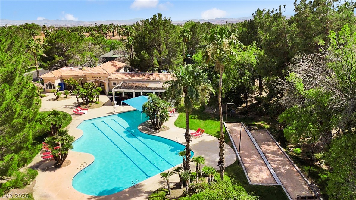 8981 Rivers Edge Drive Las Vegas, NV 89117 - Photo 63 of 69 An aerial perspective reveals the tranquil pool area and bocce courts nestled within a lush, verdant community.