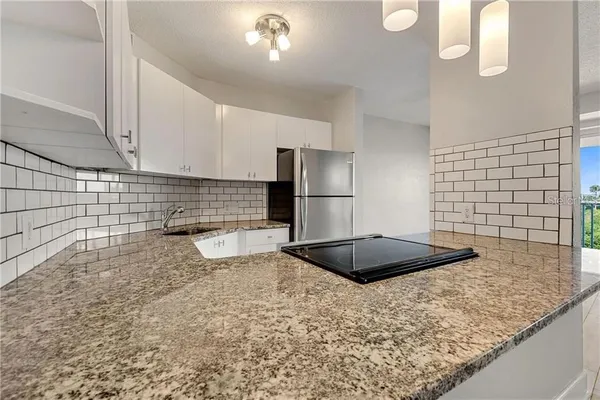 a view of a kitchen with wooden floor and a kitchen