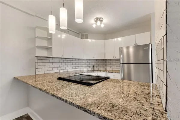 a kitchen with a sink and refrigerator