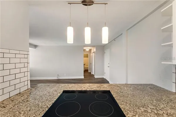 a kitchen with granite countertop a sink a stove and granite counter tops