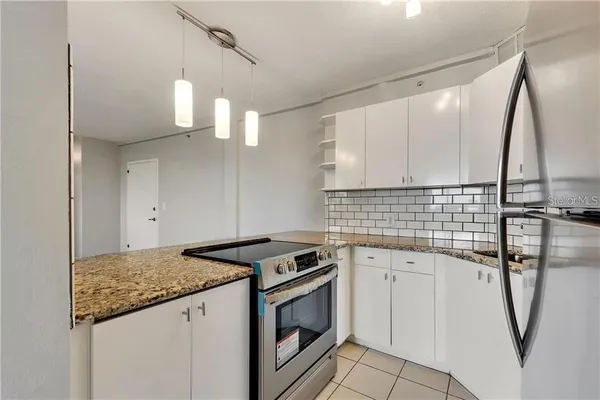 a kitchen with a sink stove and refrigerator