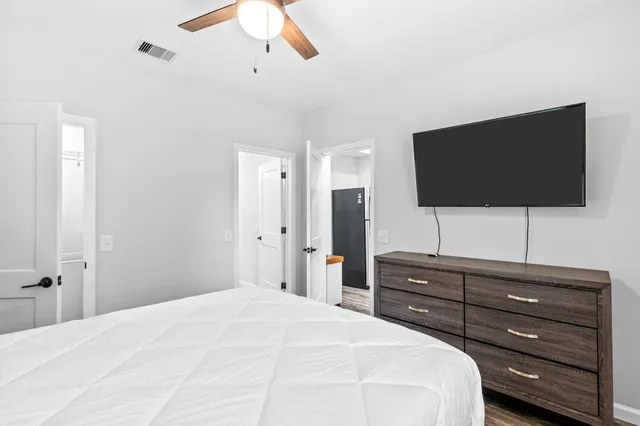 a bedroom with a bed and a flat screen tv