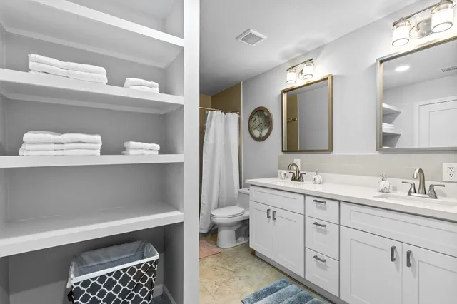 a bathroom with a sink a toilet and a mirror