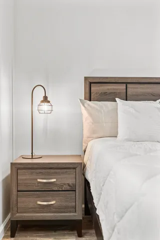 a bedroom with a bed and a mirror