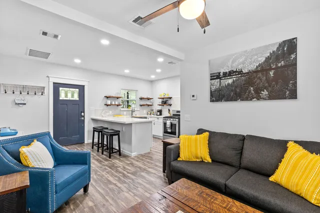 a living room with furniture and kitchen view