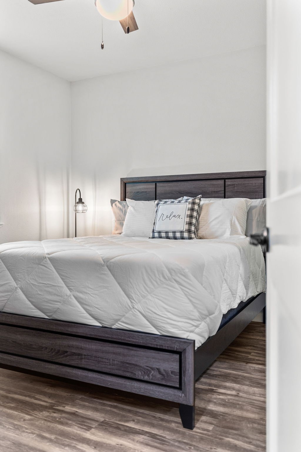 412 Waco Avenue League City, TX 77573 - Photo 25 of 28 a large bed sitting in a bedroom next to a lamp