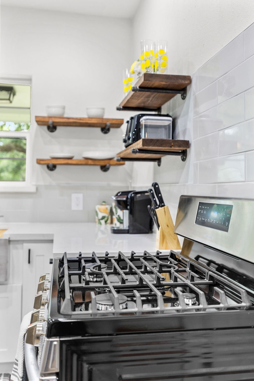 412 Waco Avenue League City, TX 77573 - Photo 26 of 28 a kitchen with a stove and wooden cabinets