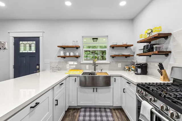 a kitchen with a sink a stove and cabinets