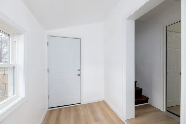 a view of small space with wooden floor and entryway