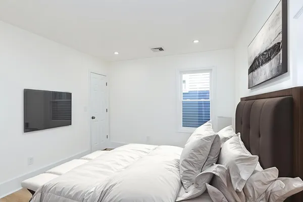 a bedroom with a bed and a television