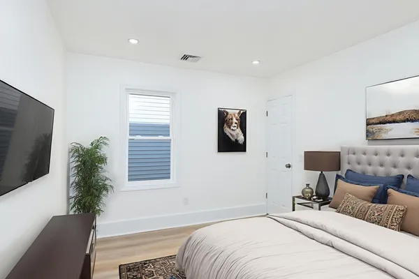 a bedroom with a bed and a potted plant