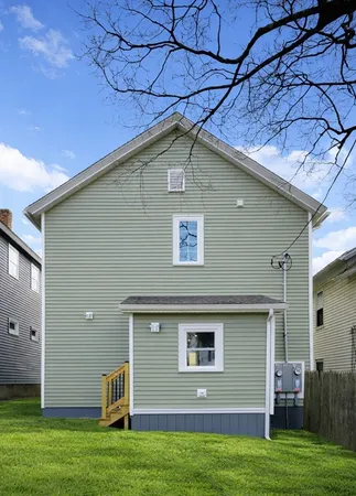 a side view of a house with a yard