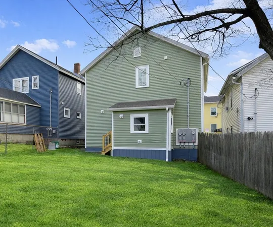 a front view of house with yard and outdoor seating