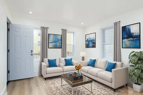 a living room with furniture and wooden floor