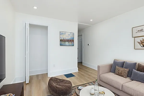 a living room with furniture and a wooden floor